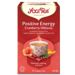 Κουτί Yogi Tea Θετικής Ενέργειας Cranberry Hibiscus 30,6 g με εικόνα ενός αχνιστού φλιτζανιού και ζωηρά floral διακοσμητικά.